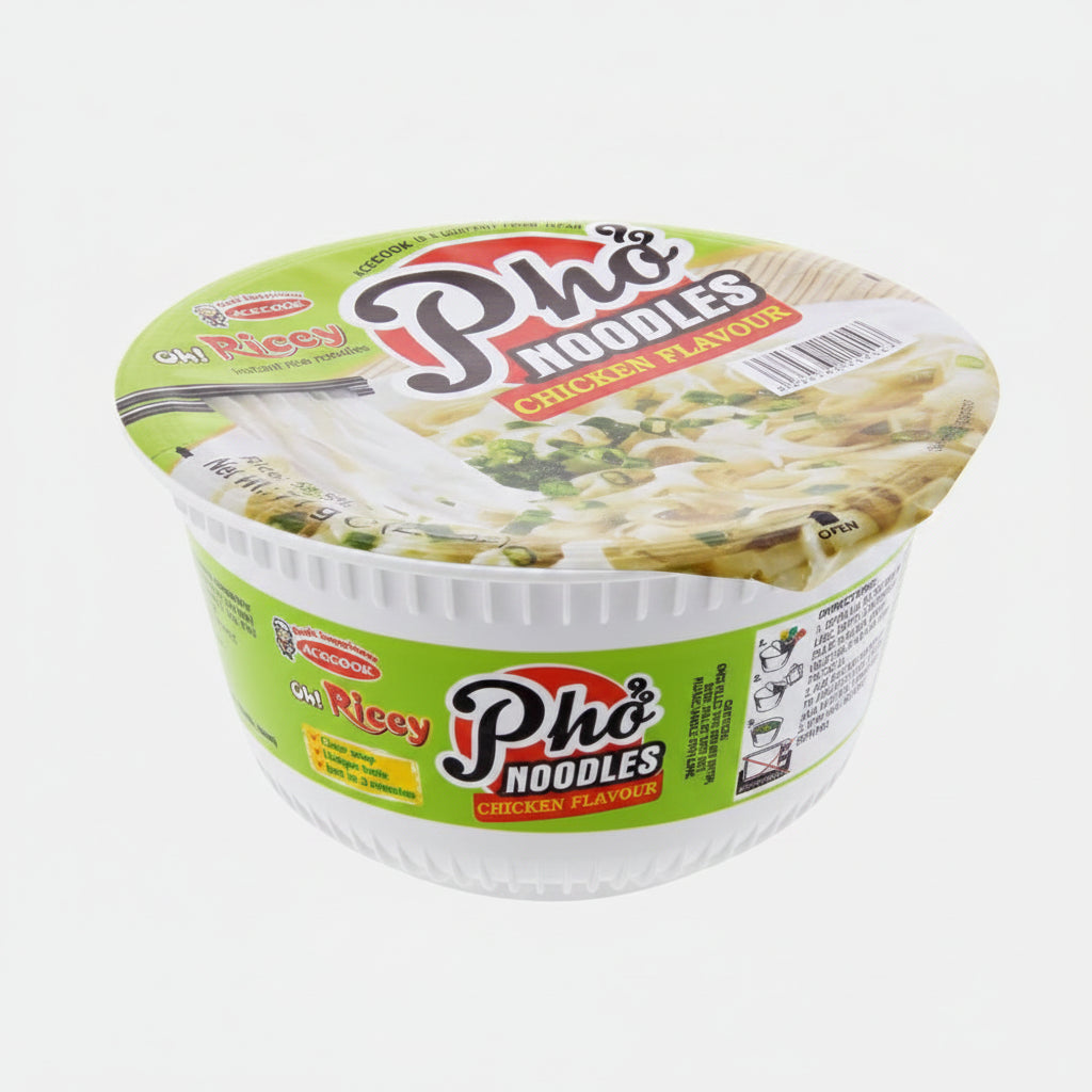 A cup of Pho Noodles Chicken Flavour instant noodles by Gia Riccy, in a white plastic bowl with a green and white label and a clear plastic lid showing the noodle soup inside.