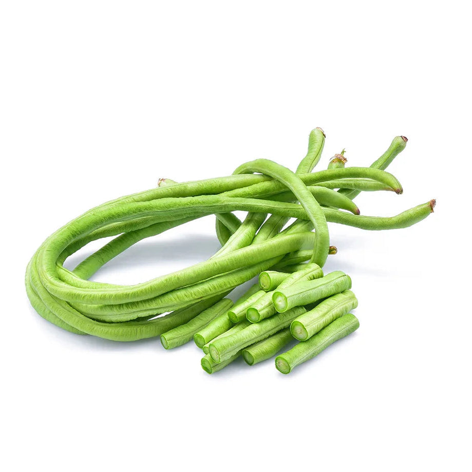A pile of fresh green long beans with some cut ends, arranged on a plain white background.