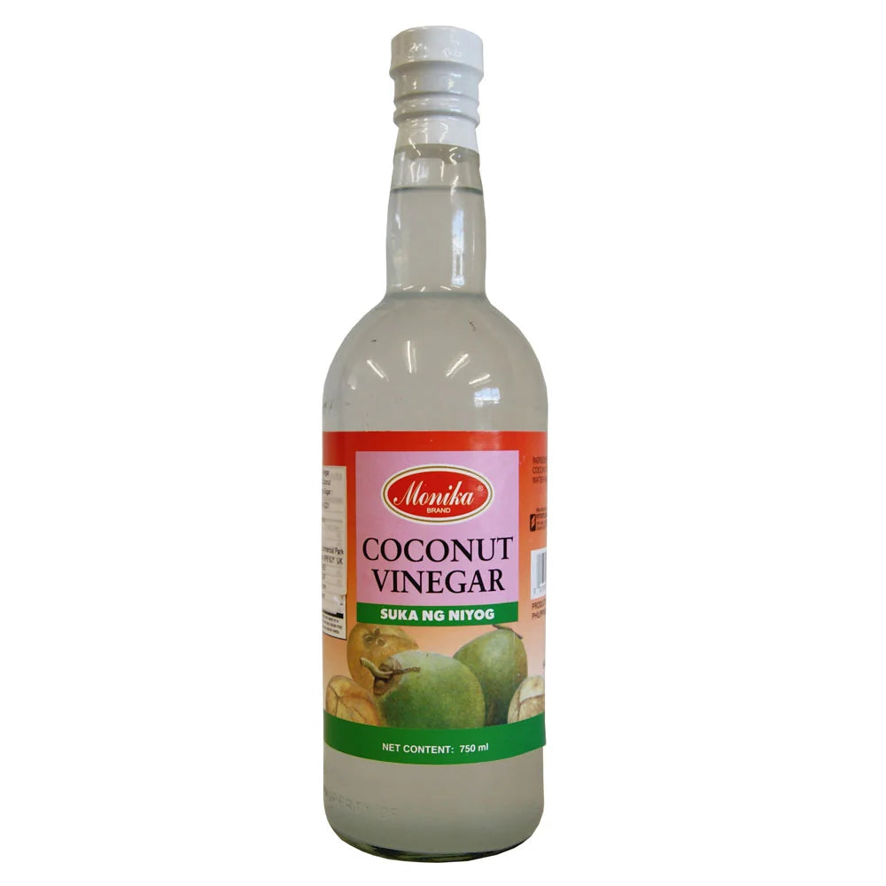 A 750 mL glass bottle of Menka Coconut Vinegar (Sula ng Nito) with a white cap and a colorful label showing coconuts, set against a plain white background.