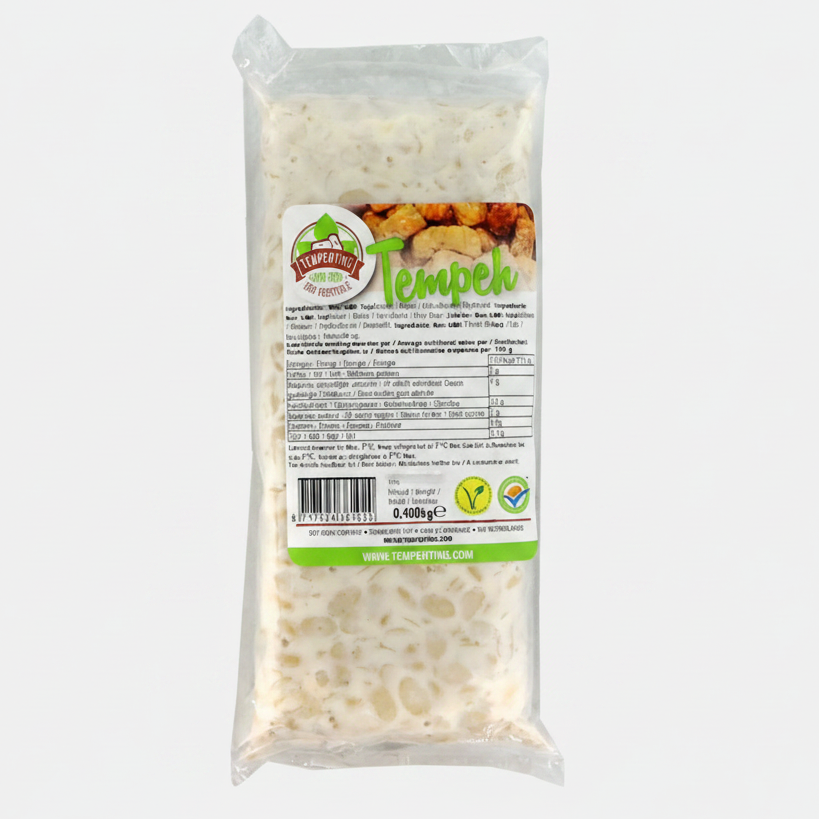 A packaged food product labeled 'Tempeh' in a clear plastic bag with a printed front label. The product inside appears off-white and textured.
