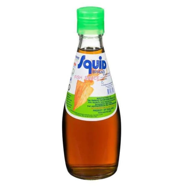 A bottle of Squid Brand fish sauce with a green cap and a white and green label, containing amber-colored liquid, set against a plain white background.