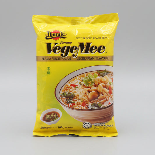 A package of Thumie Penang VegeMee vegetarian instant noodles, 80g, in its signature bright yellow packaging, displayed on a dark brown wooden surface.