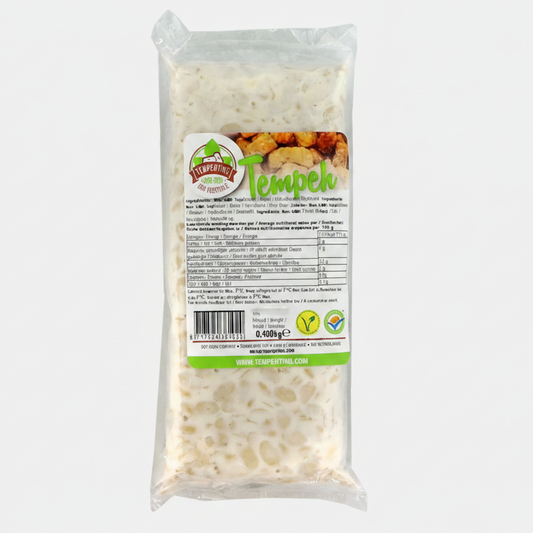 A packaged food product labeled 'Tempeh' in a clear plastic bag with a printed front label. The product inside appears off-white and textured.