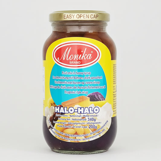 A glass jar of Momika Brand Halo-Halo dessert, featuring a bright yellow label with red and blue branding, set against a plain white background.
