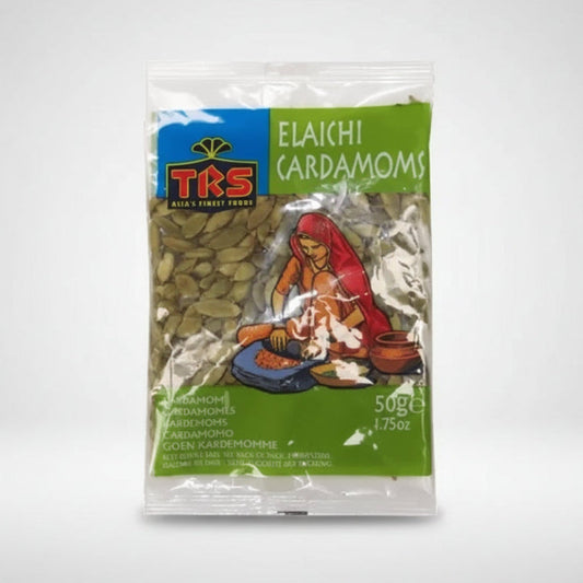 A 50g package of TKS Elaichi Cardamoms (Gojen Kardemomphe) seeds, featuring a green and blue label with an illustration of a woman grinding spices.