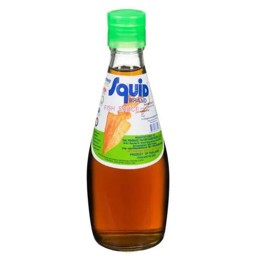 A bottle of Squid Brand fish sauce with a green cap and a white and green label, containing amber-colored liquid, set against a plain white background.