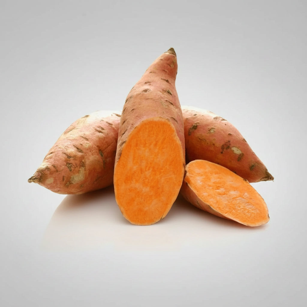Four sweet potatoes on a white background, with two cut open to show the bright orange interior.
